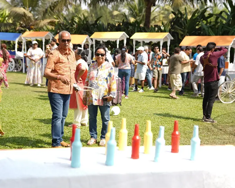 Wedding guests enjoying colourful lawn games at an outdoor celebration